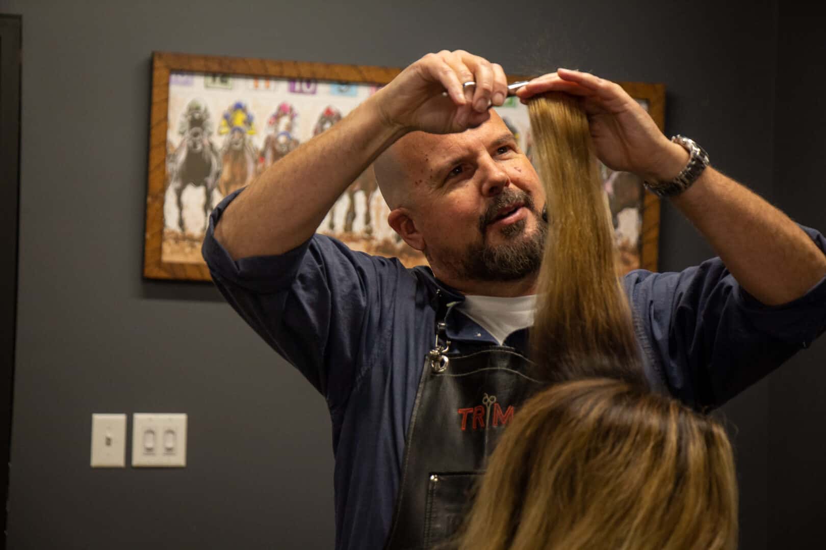 Hair stylist trimming hair